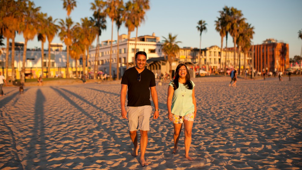 kavita and husband walking on the beach